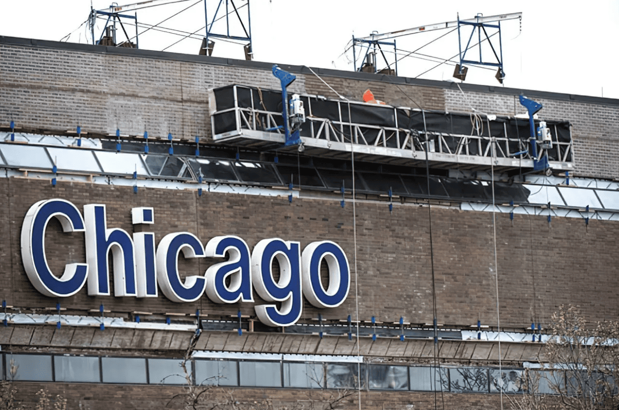 Chicago sign on a brick building with rooftop equipment and snow on top