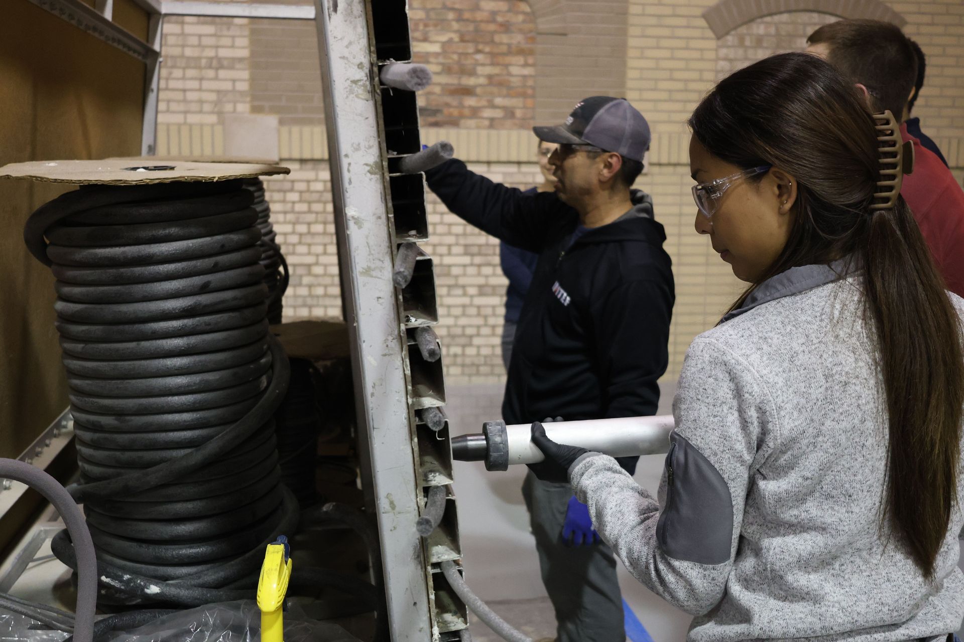 A group of people are working on a machine in a factory.