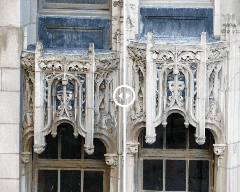 Ornate white Gothic window carvings on a blue-gray building facade