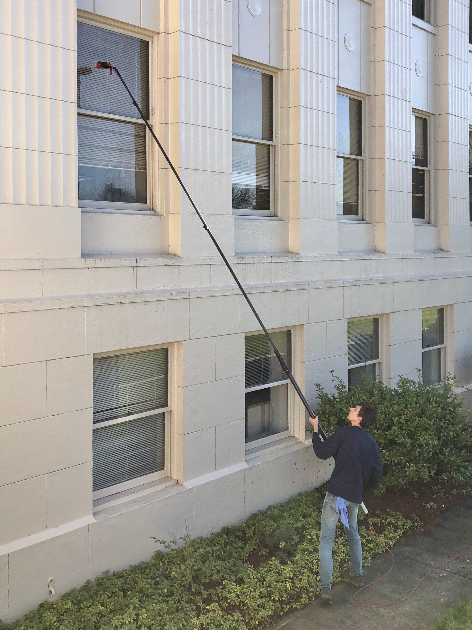 Man Using Window Cleaner — Albany, OR — Grover Cleaning Service Inc
