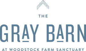 The Gray Barn logo at Woodstock Farm Sanctuary in gray and blue