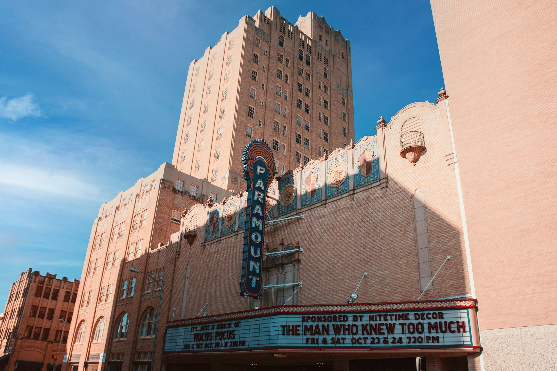Paramount Theatre in beige brick, marquee showing