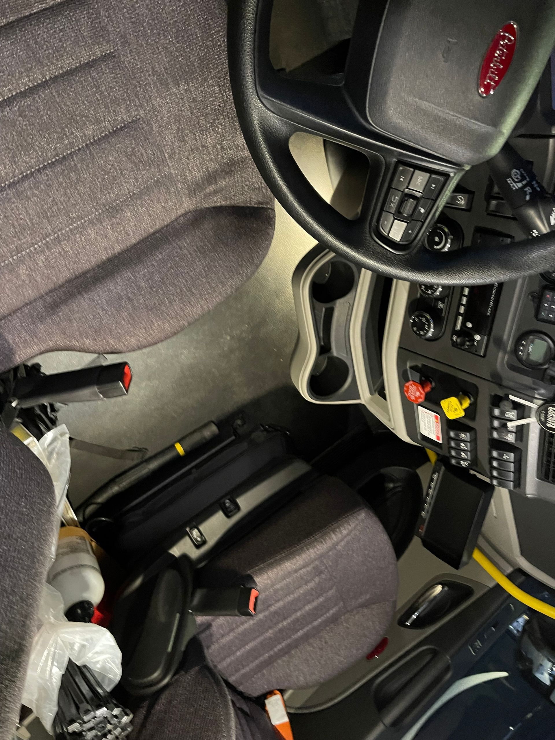 A person is sitting in the driver 's seat of a peterbilt truck