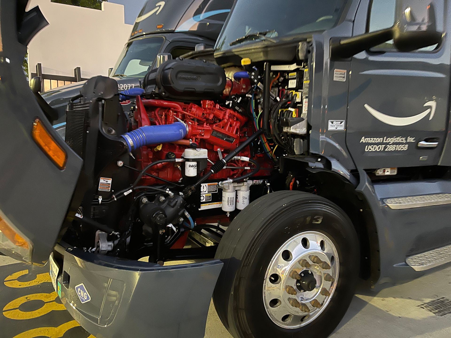 An amazon truck with its hood open