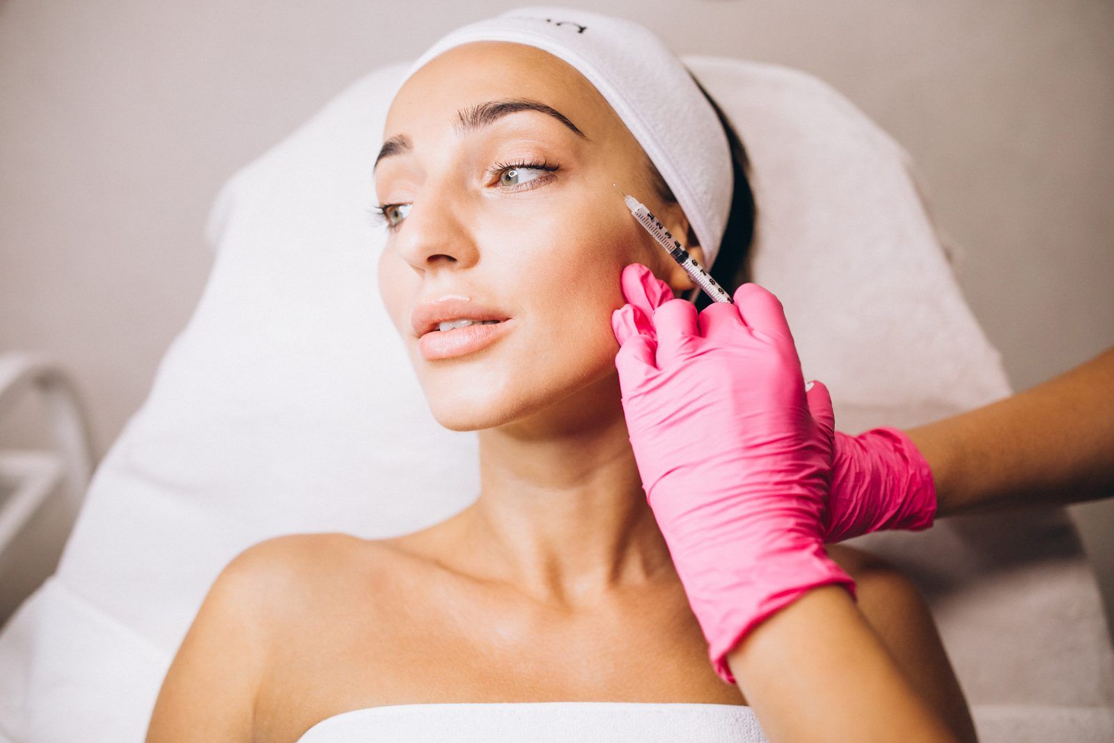 Provider performing a Rejuran PDRN skin booster treatment on a patient's cheek