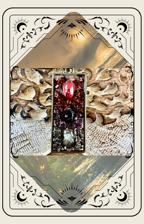 Tarot card of a rectangular pendant with layered crystals in shades of red, purple, and clear set on carved wooden surface.