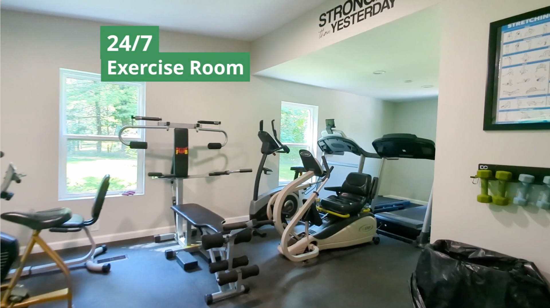 A 24/7 exercise room with a lot of exercise equipment at Shiawassee Shores Retirement Park