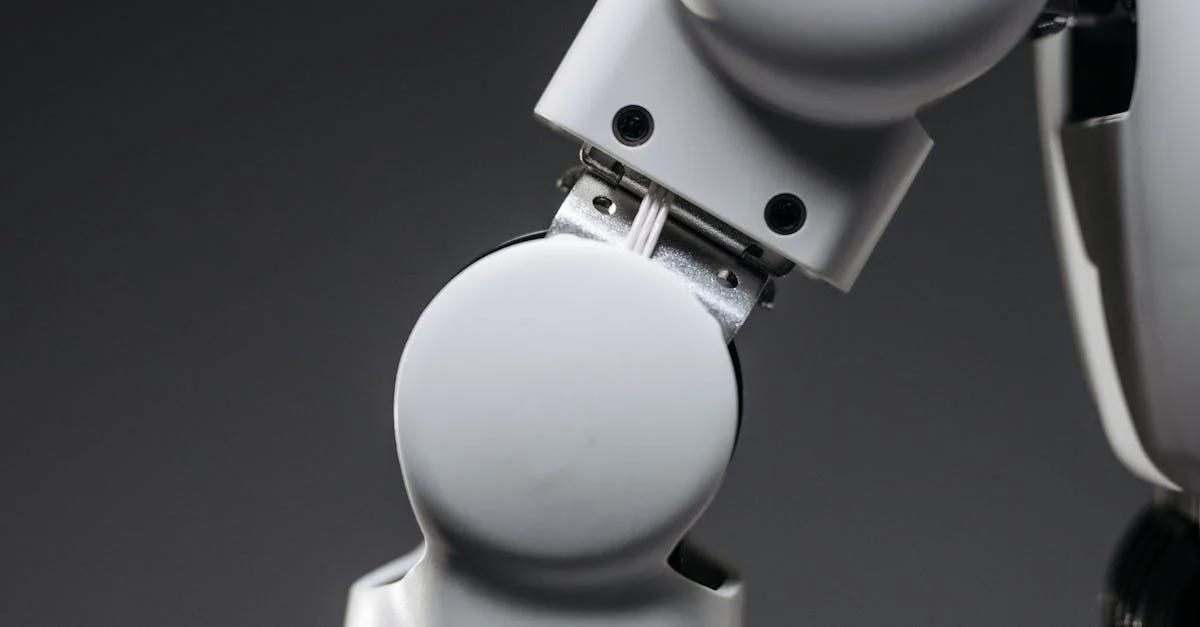 A close up of a robot 's arm with a button on it.