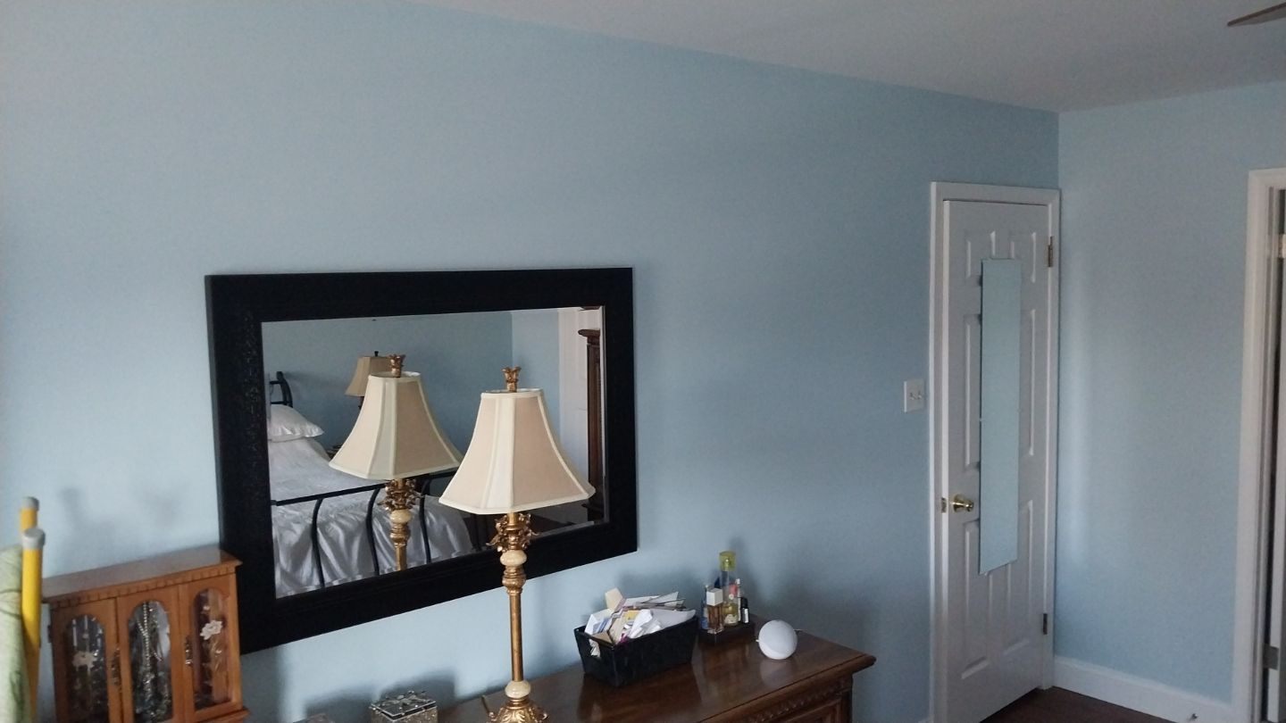 Master bedroom interior painted light blue with matching door and baseboard – after project in Hatfield, PA by Liberty & Freedom Painting.