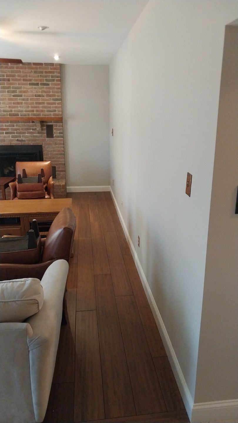 Living room with freshly painted neutral walls and white baseboards – after interior painting project in Hatfield, PA by Liberty & Freedom Painting.