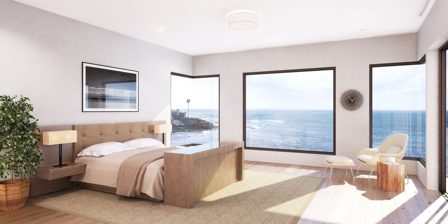 Modern oceanfront bedroom with a neutral color palette, featuring a plush bed, large windows, and a cozy armchair.