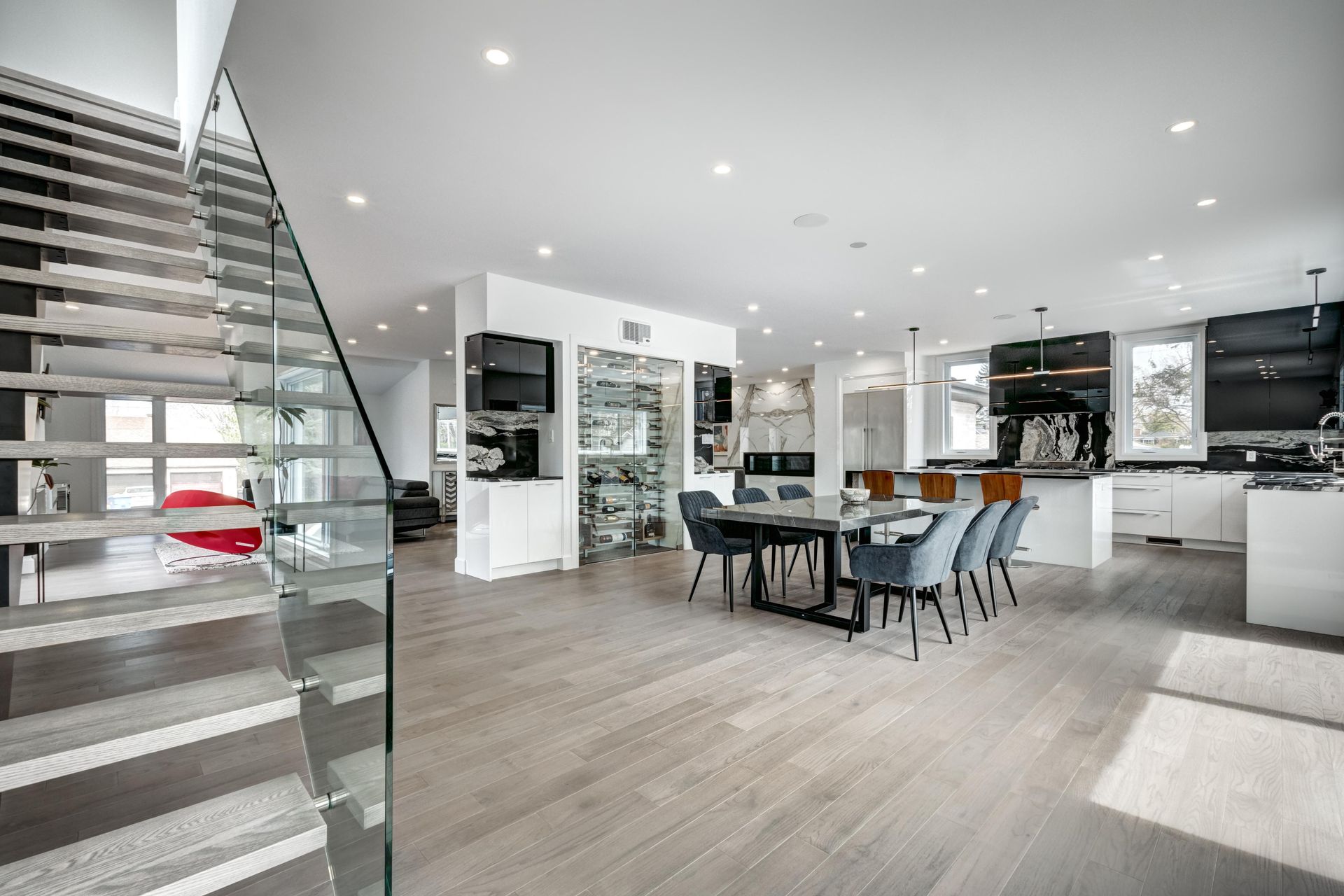 A kitchen with a large island and stools in it.