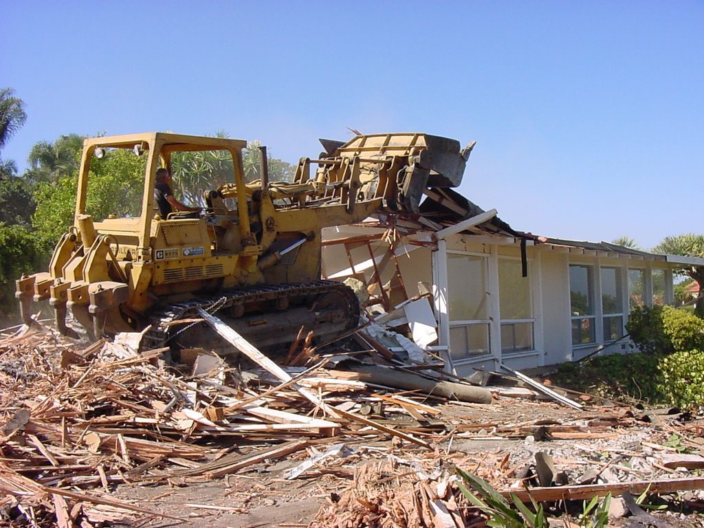 A bulldozer is demolishing a house.