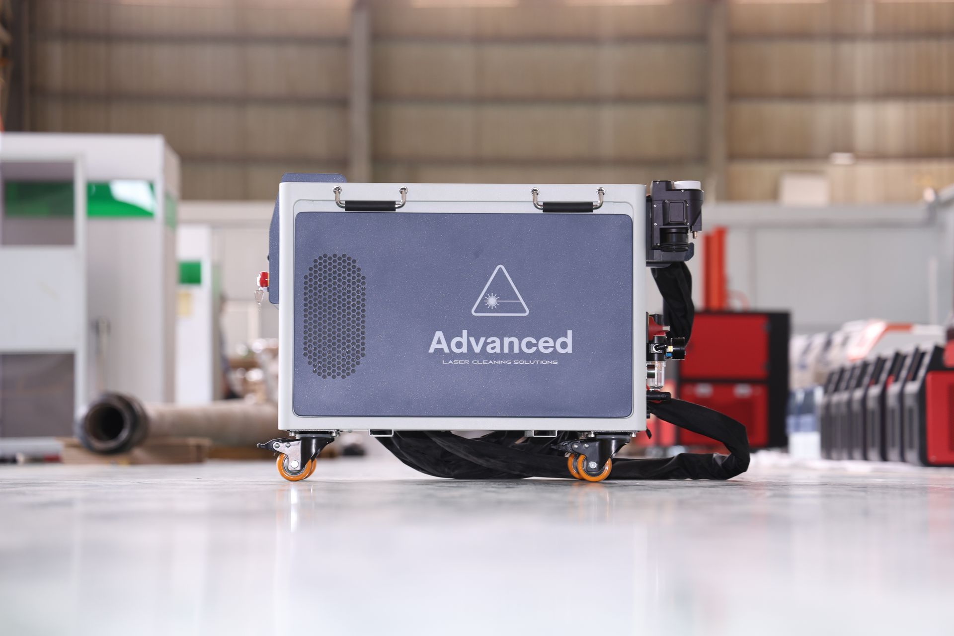 A gray and black industrial robot on wheels with the word 