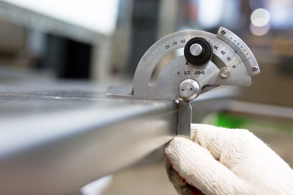Person in Work Gloves Using a Protractor — Rob Powell Plumbing Pty Ltd in Goonellabah, NSW