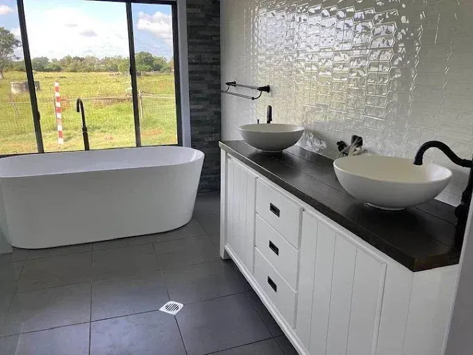 White double vanity with vessel sinks and mirror cabinets, leading to a separate toilet. — Rob Powell Plumbing Pty Ltd in Coraki, NSW