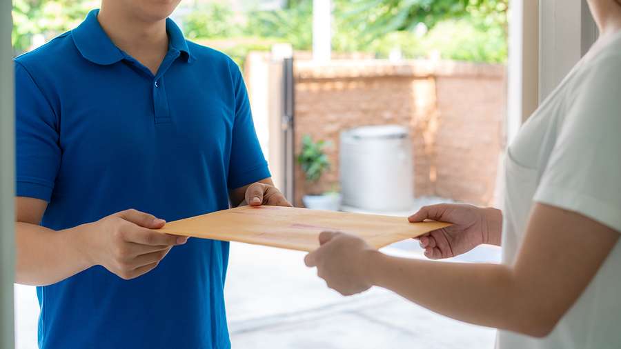 Guy handing over a letter from court