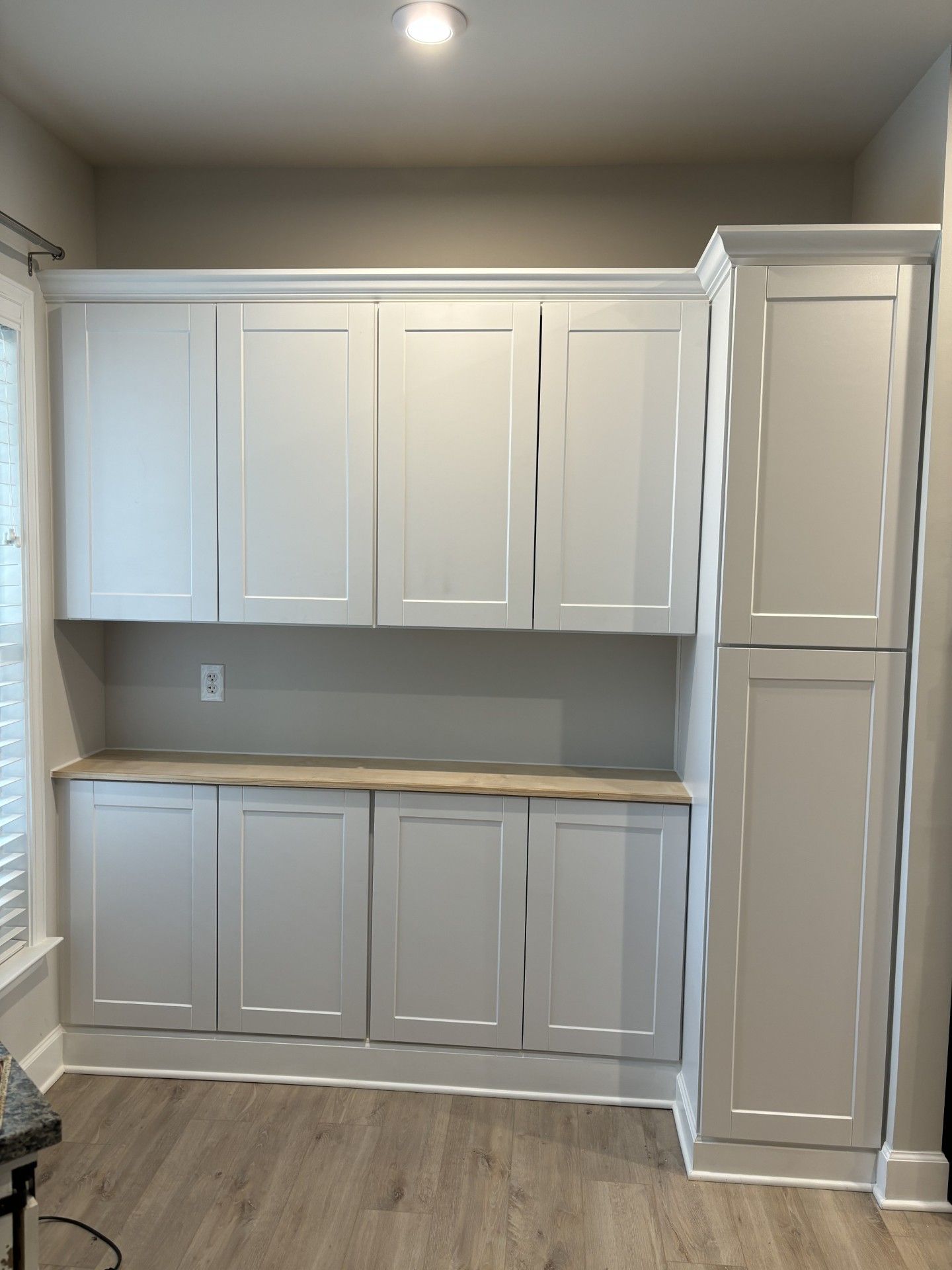 White built-in cabinets and countertop against a wall in a room | Decatur, IL