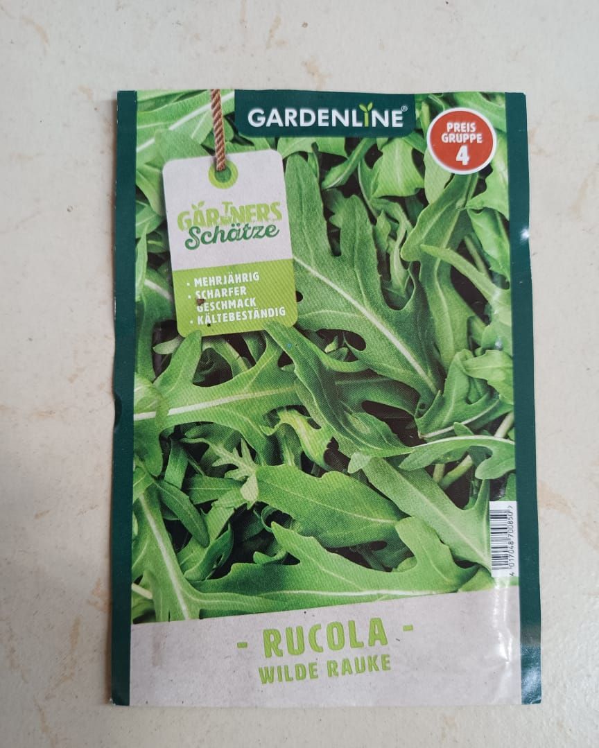Packet of Gardeline wild rocket seeds with green arugula leaves on the front