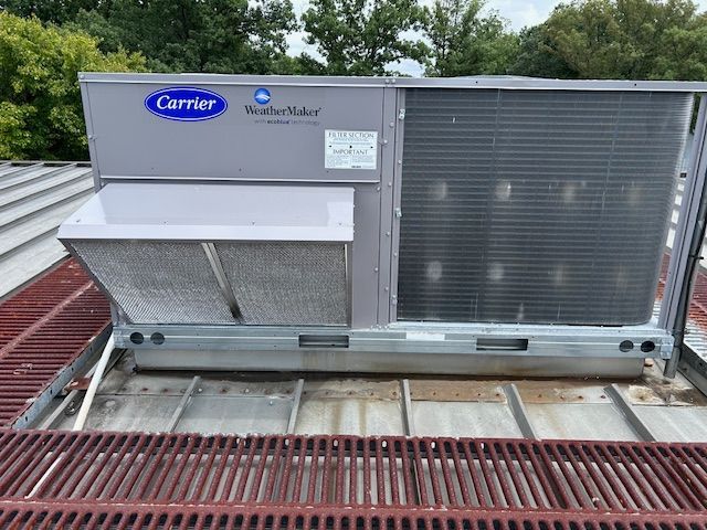 Carrier rooftop HVAC unit on a building with a metal roof.