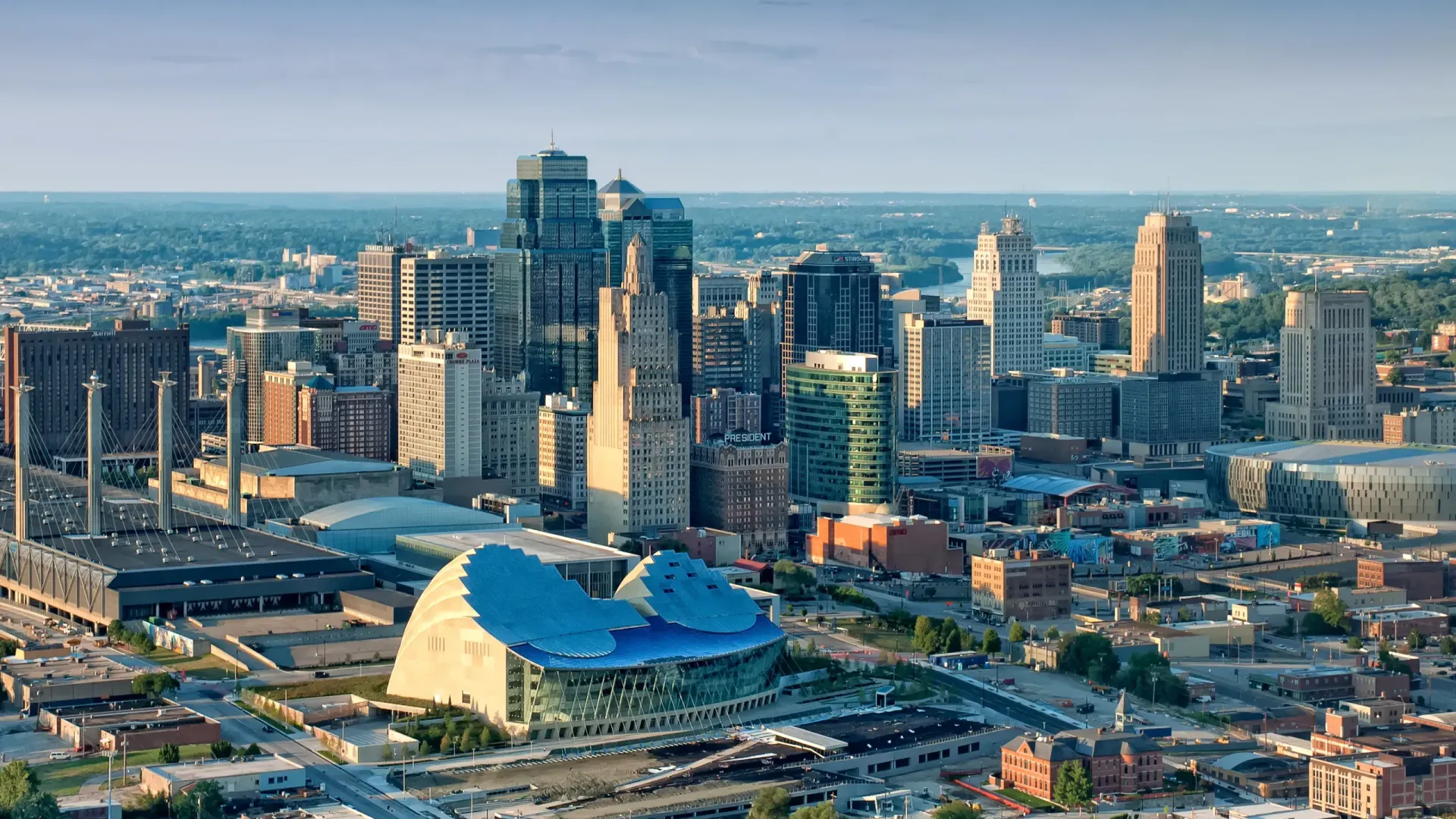 An aerial view of a city with a lot of buildings and a large dome in the middle of the city.