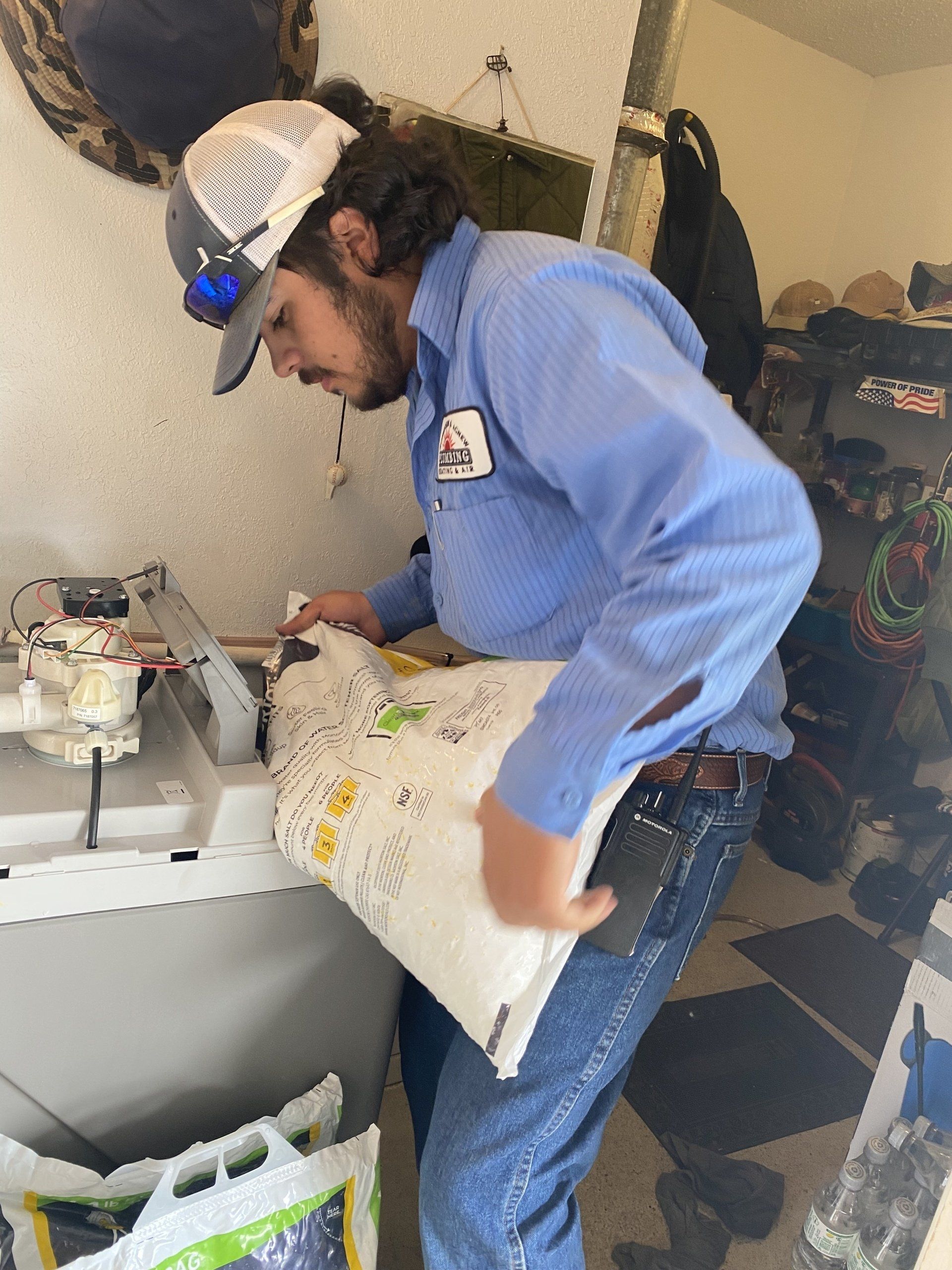 Fixing White Sink Pipe With Wrench — Levelland, TX — Robertson & Agnew Plumbing Heating & Air