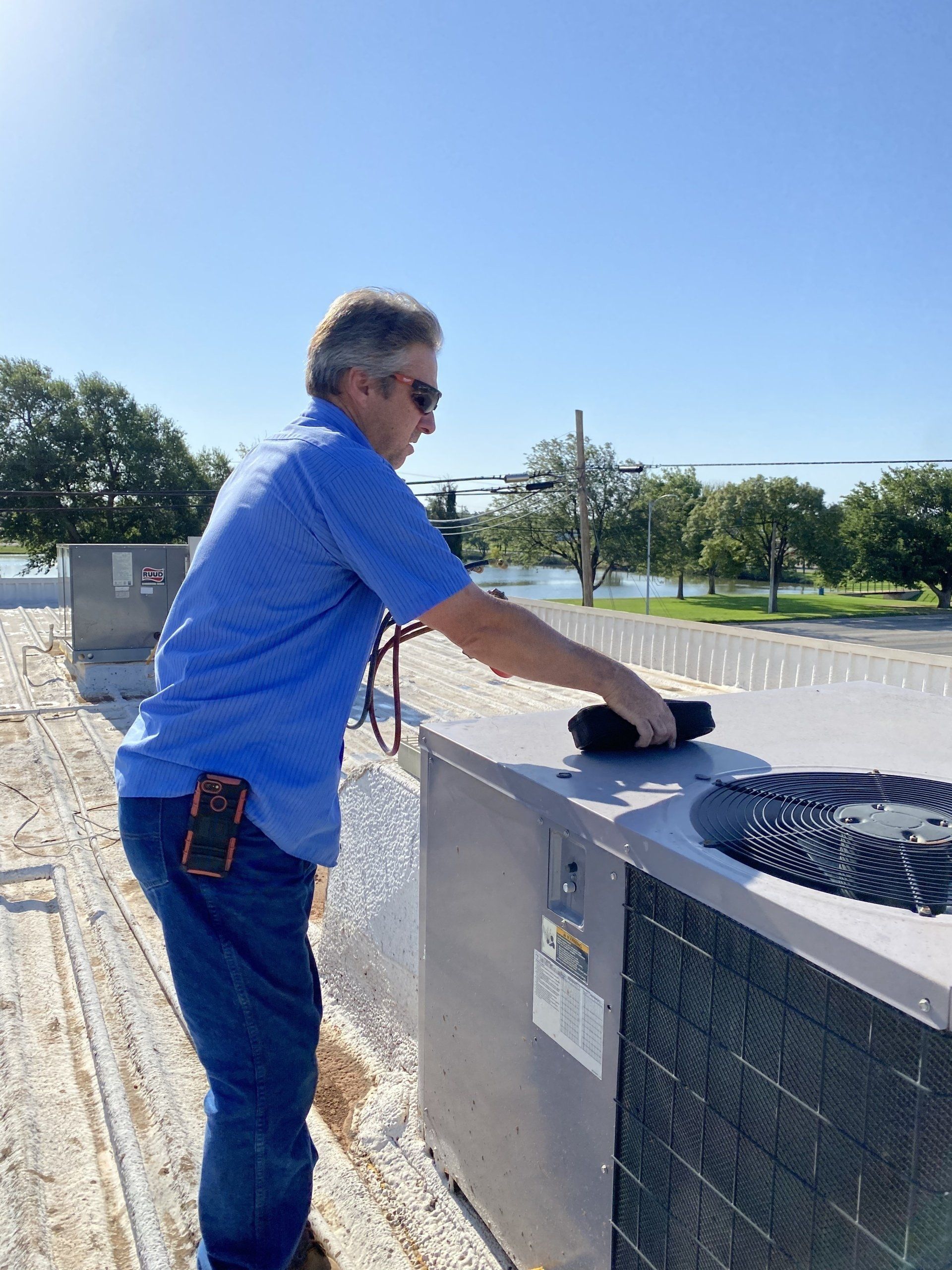 Plumber Holding A Wrench — Levelland, TX — Robertson & Agnew Plumbing Heating & Air