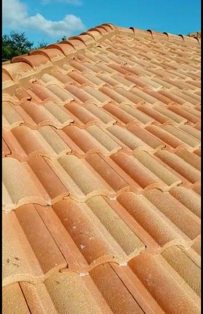 Close-up of a terracotta tiled roof against a blue sky