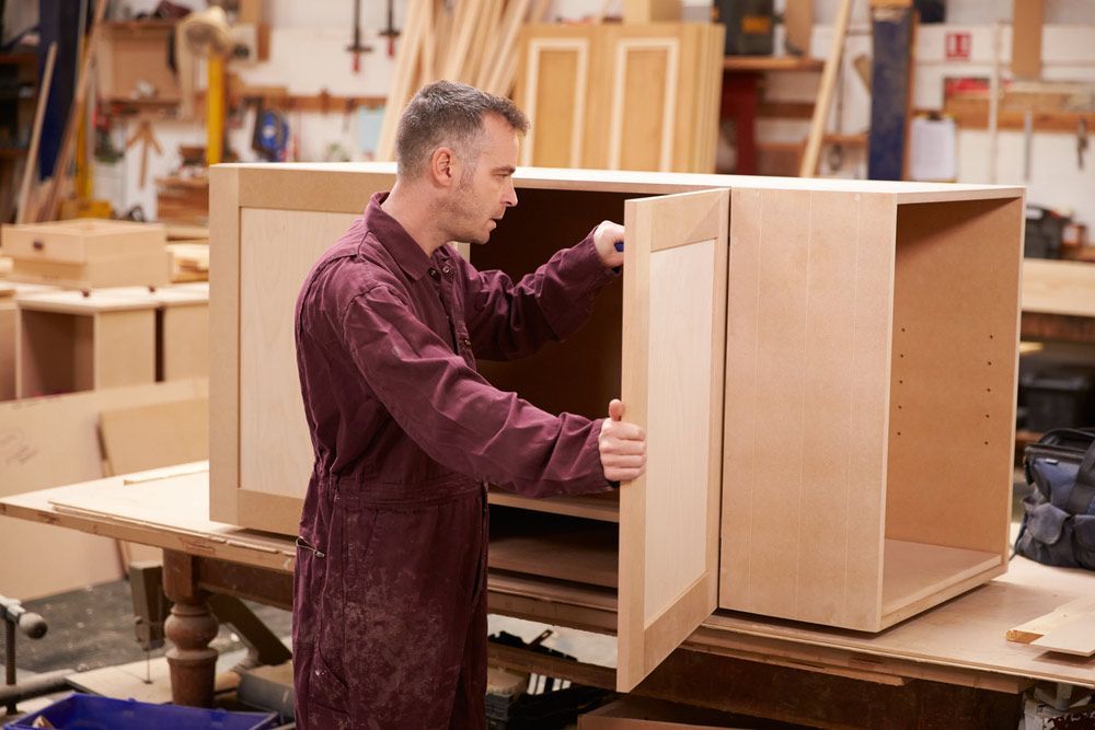 Carpenter Building Furniture In Workshop — Prime Edge Joinery Pty Ltd in Flinders, NSW