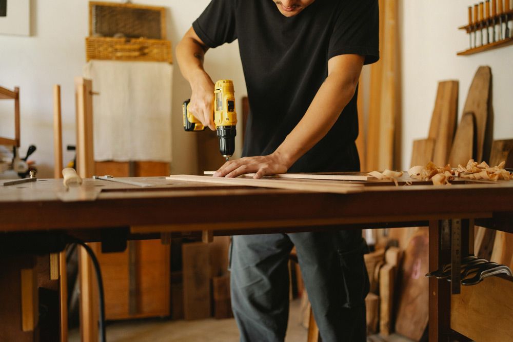 Craftsman With Tools Drilling The Wood — Prime Edge Joinery Pty Ltd in Gold Coast, QLD