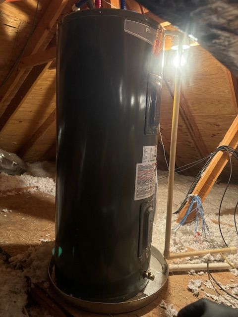 A black water heater is sitting in the attic
