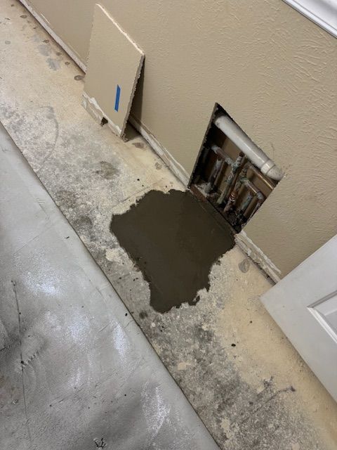 A hole in the wall is being filled with concrete