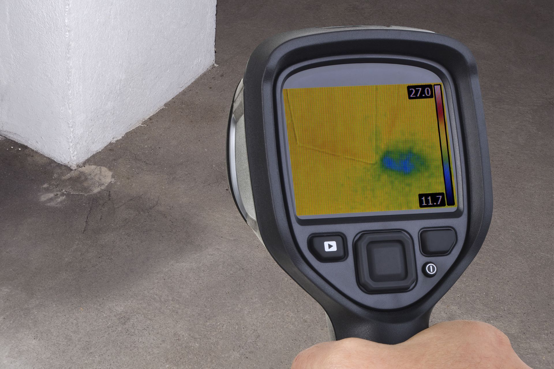 A person is holding a thermal camera in their hand