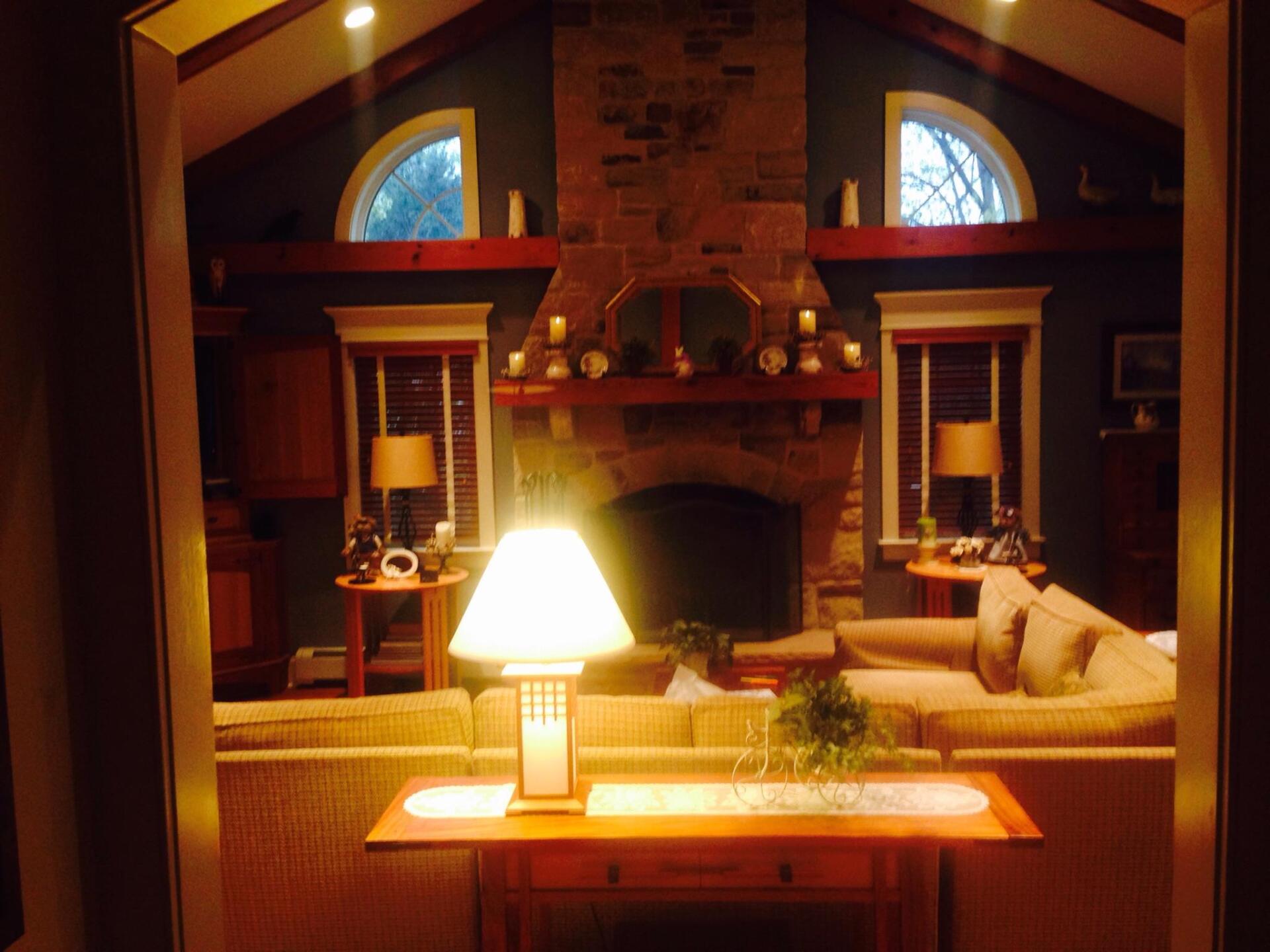 A living room with a fireplace and a lamp