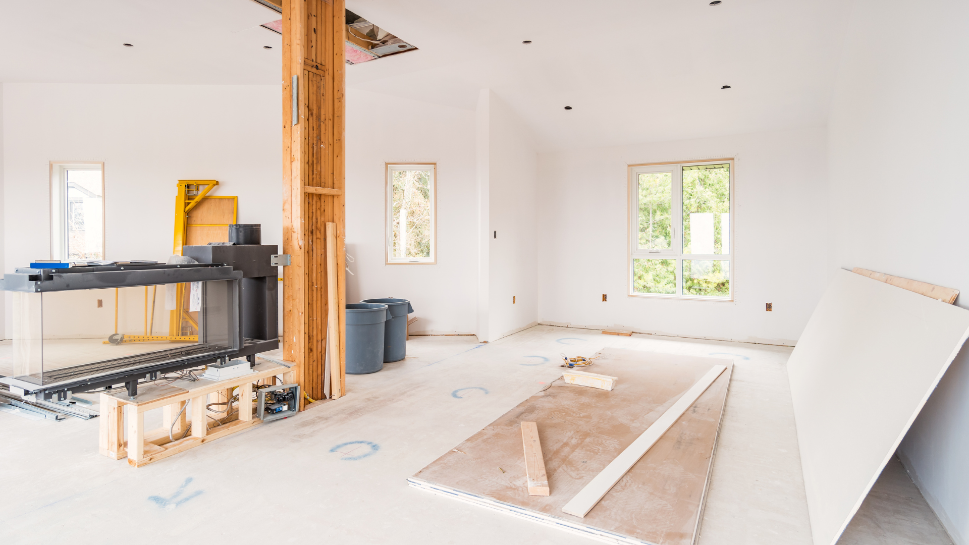 An empty room with a wooden post in the middle of it.