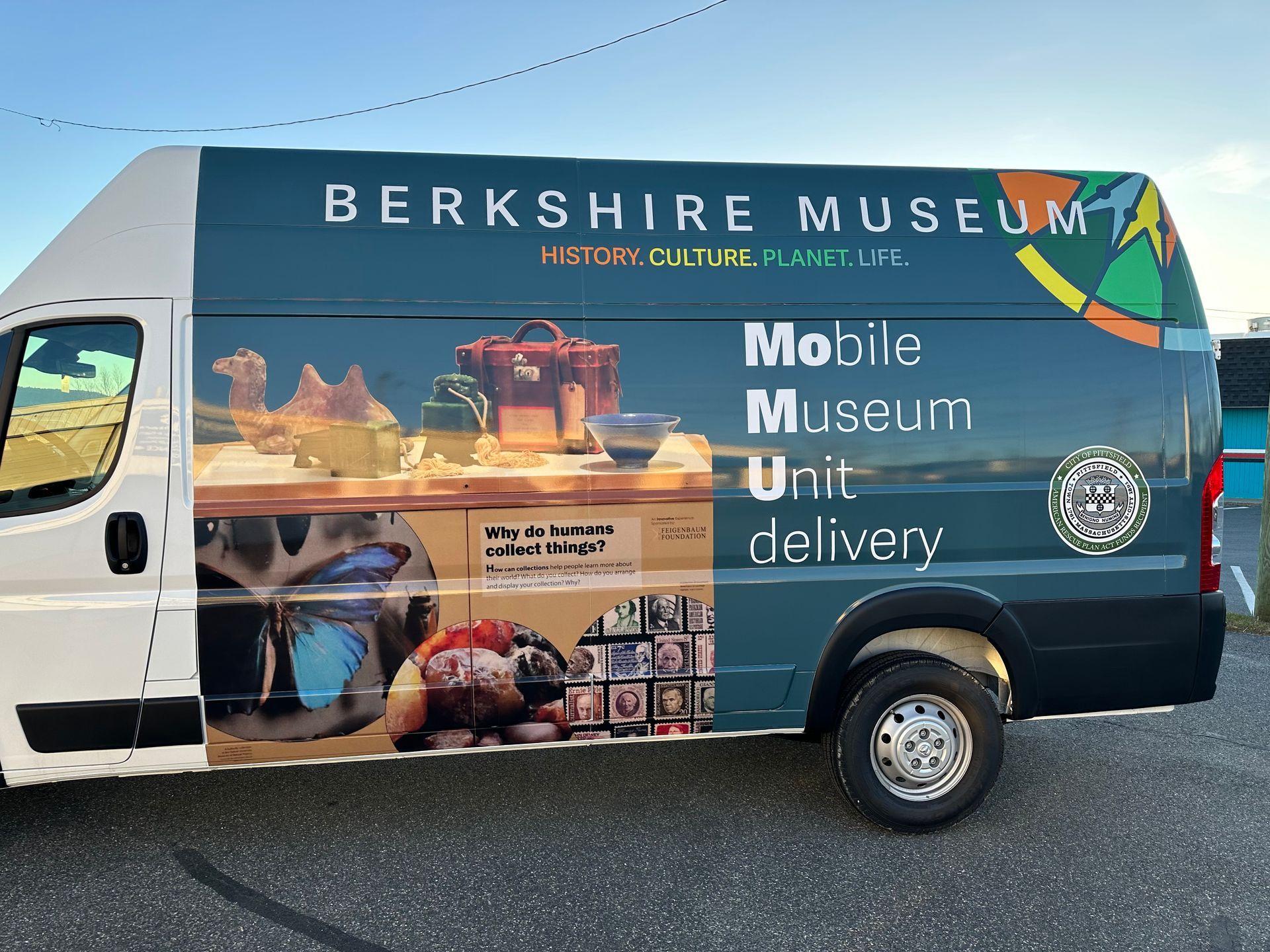 A berkshire museum van is parked in a parking lot