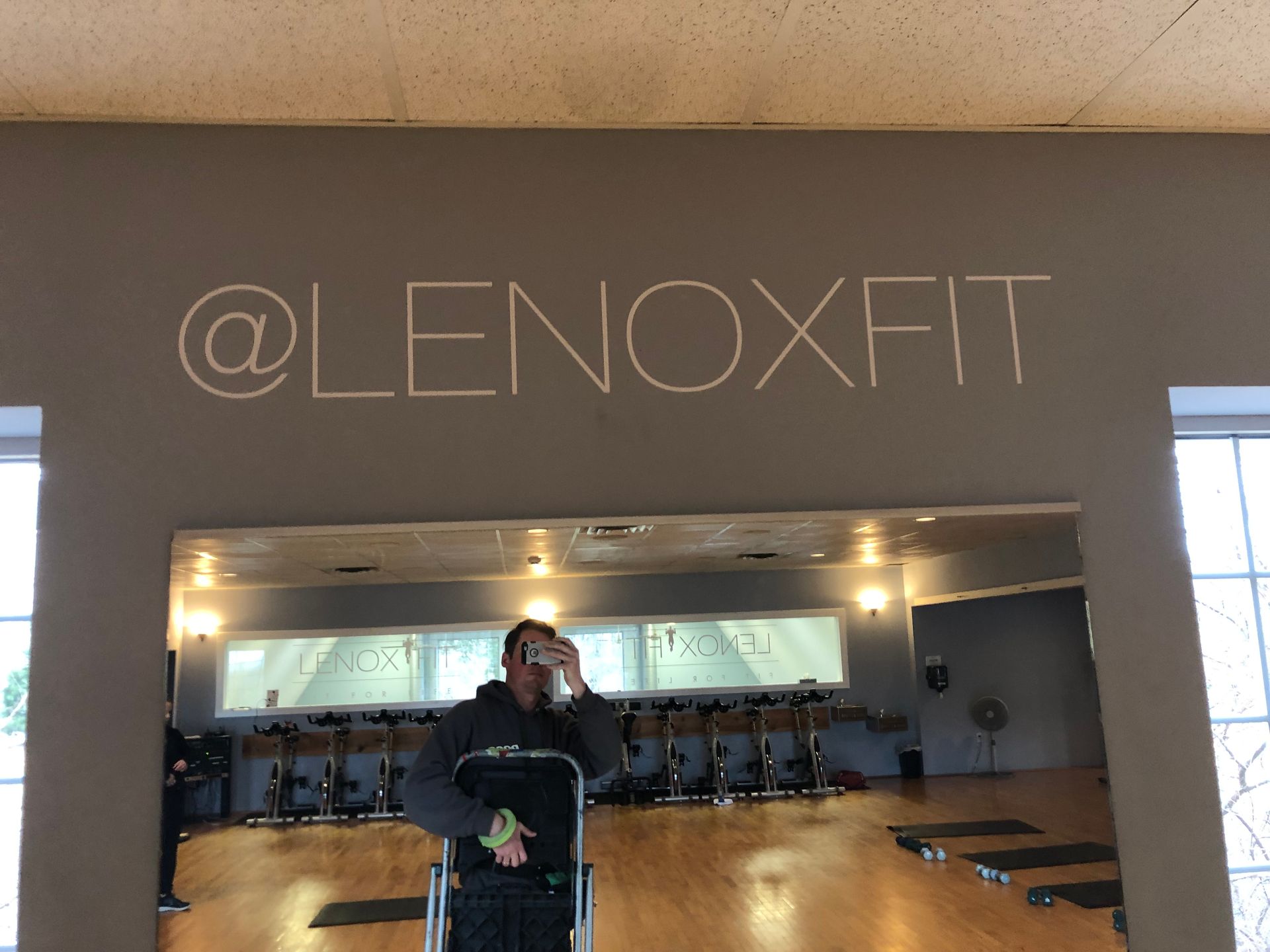 A man taking a picture of himself in a lenoxfit gym