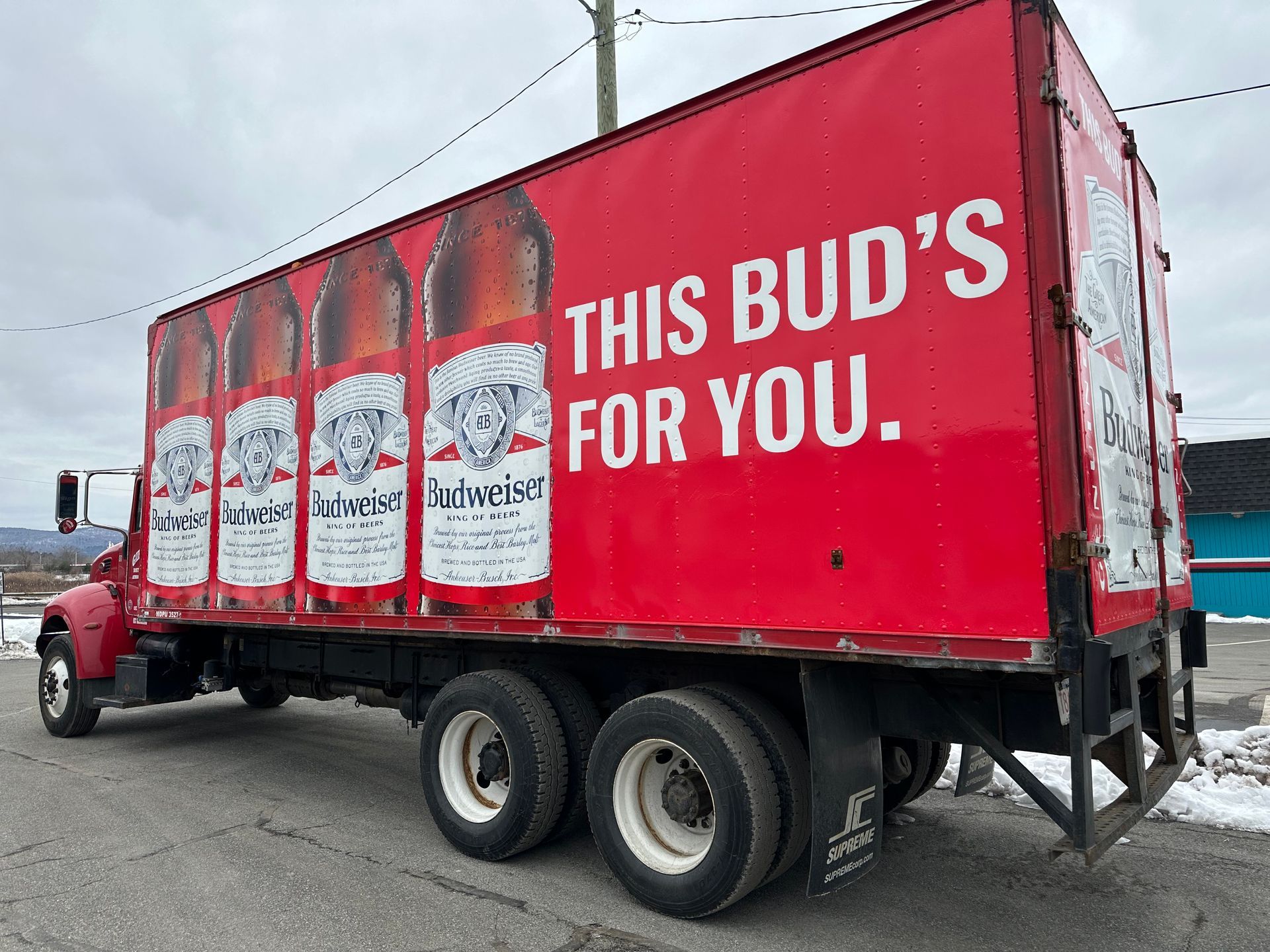 A red truck that says this bud 's for you