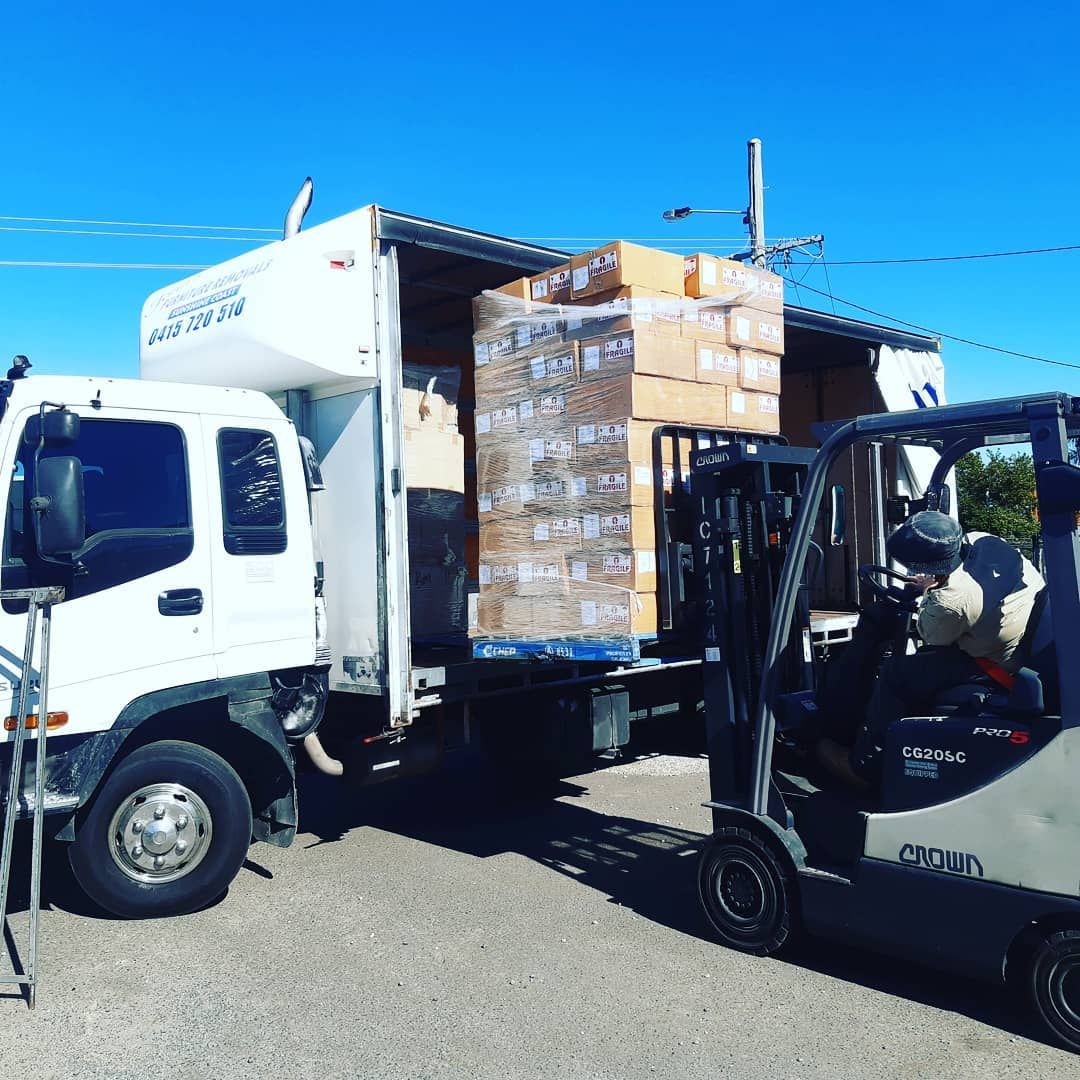Forklift Loading Boxes From a Delivery Truck. Sunny Day, Blue Sky — John's Furniture Removals in Yandina, QLD