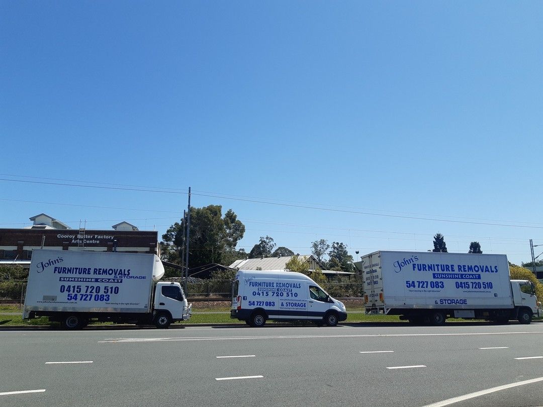 Three White Moving Trucks Parked on the Side of a Road — John's Furniture Removals in Yandina, QLD