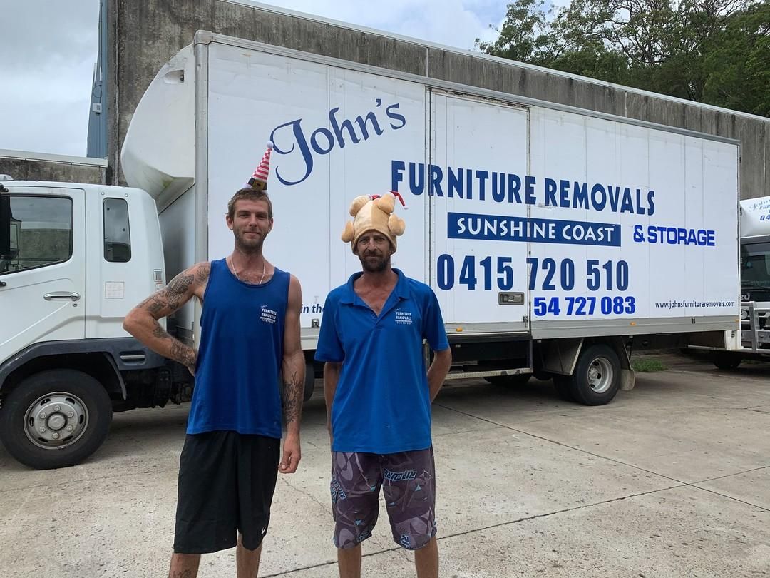Two Men Stand in Front of a Moving Truck With John's Furniture Removals — John's Furniture Removals in Bundaberg, QLD
