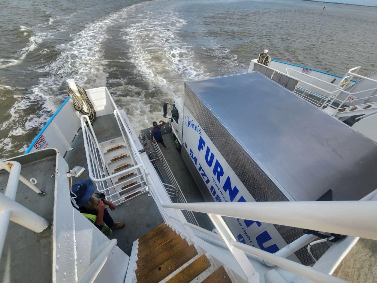 Two Workers Guide the Truck Onto the Ramp, a View From the Deck — John's Furniture Removals in Gladstone, QLD