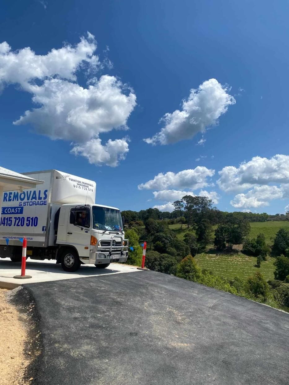 Moving Truck Parked on a Paved Driveway — John's Furniture Removals in Sunshine Coast, QLD