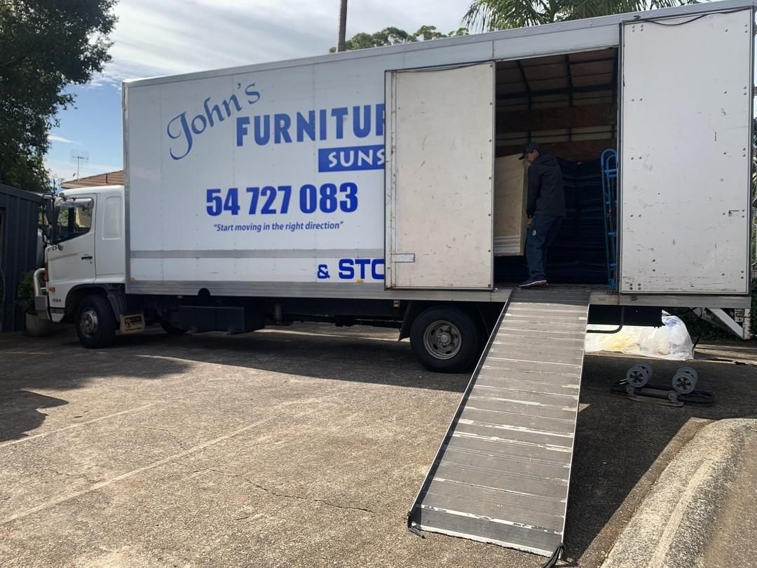 A Moving Truck With Ramp Open is Parked at a Loading Zone — John's Furniture Removals in Maryborough, QLD