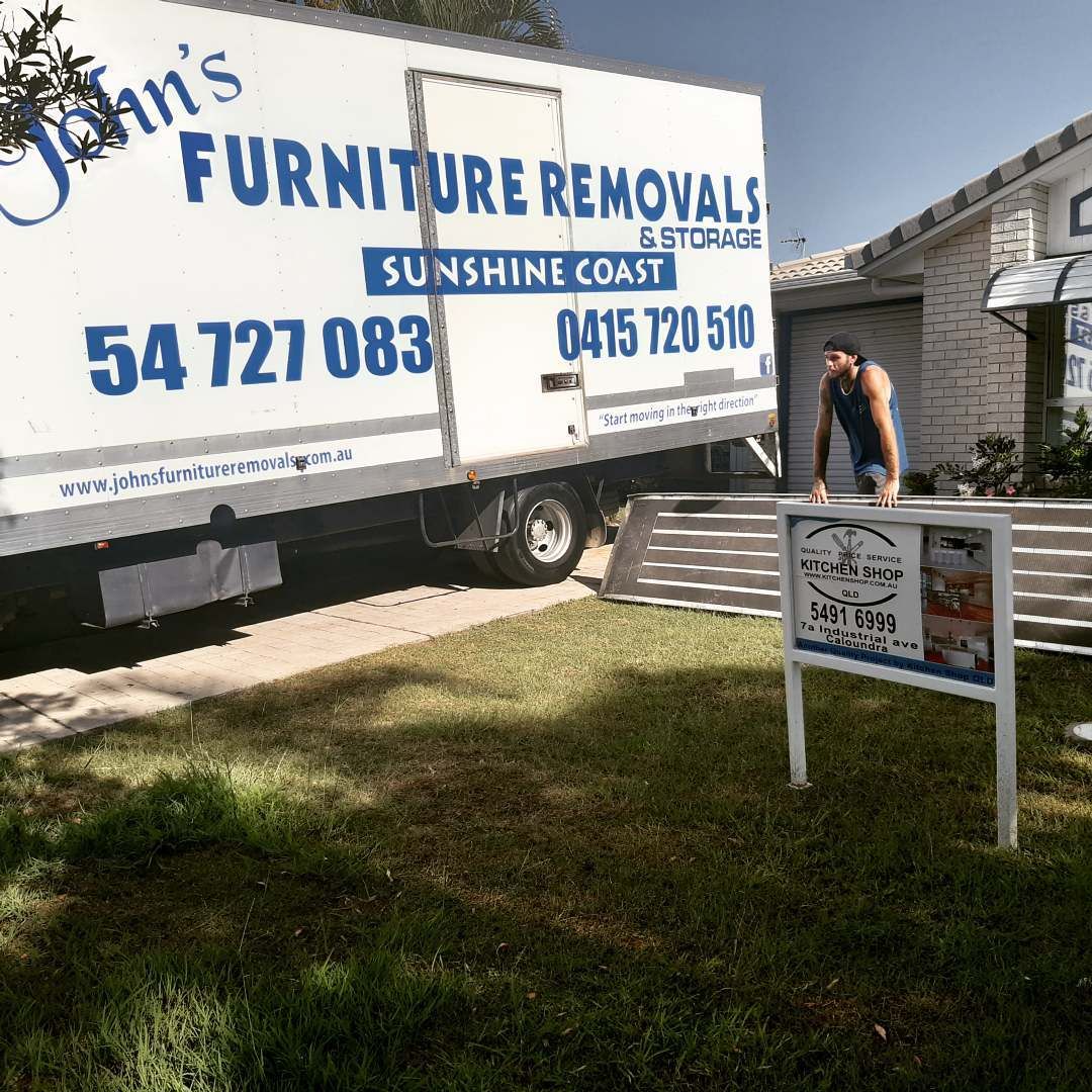 Man Lifting Furniture Next To Moving Van — John's Furniture Removals in Mountain Creek, QLD