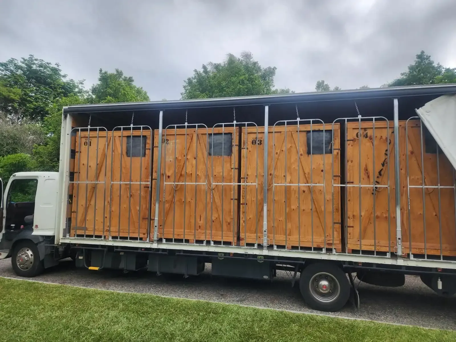 Truck Carrying Four Wooden Stalls — John's Furniture Removals in Buderim, QLD
