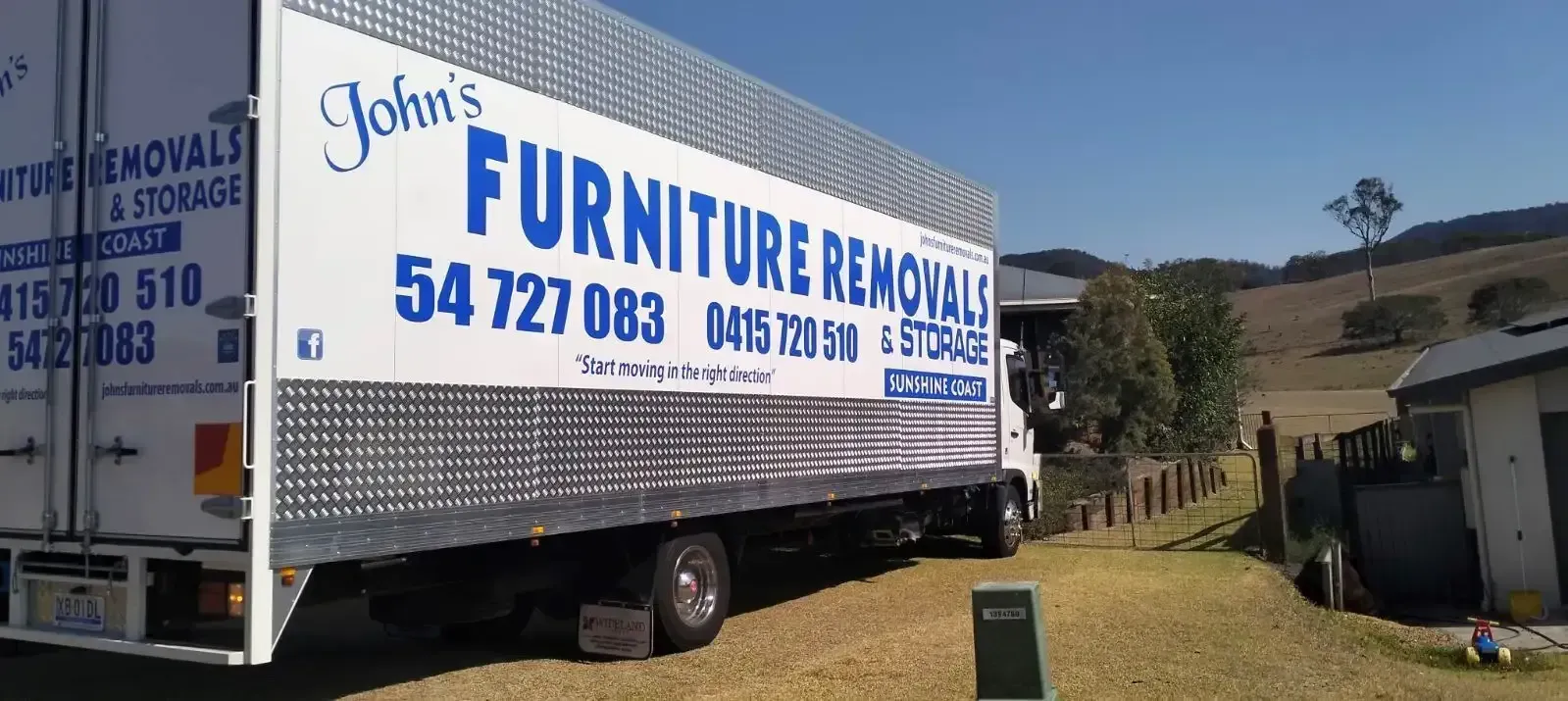 Moving Truck Parked in a Driveway Saying “John's Furniture Removals”
— John's Furniture Removals in Sunshine Coast, QLD