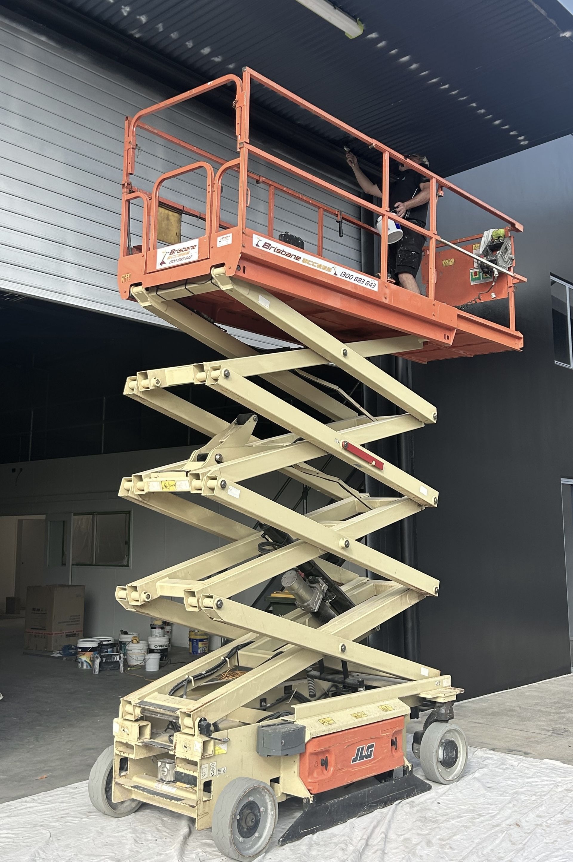 A Person Painting a Wall — Commercial Asset Maintenance In Beerwah, QLD