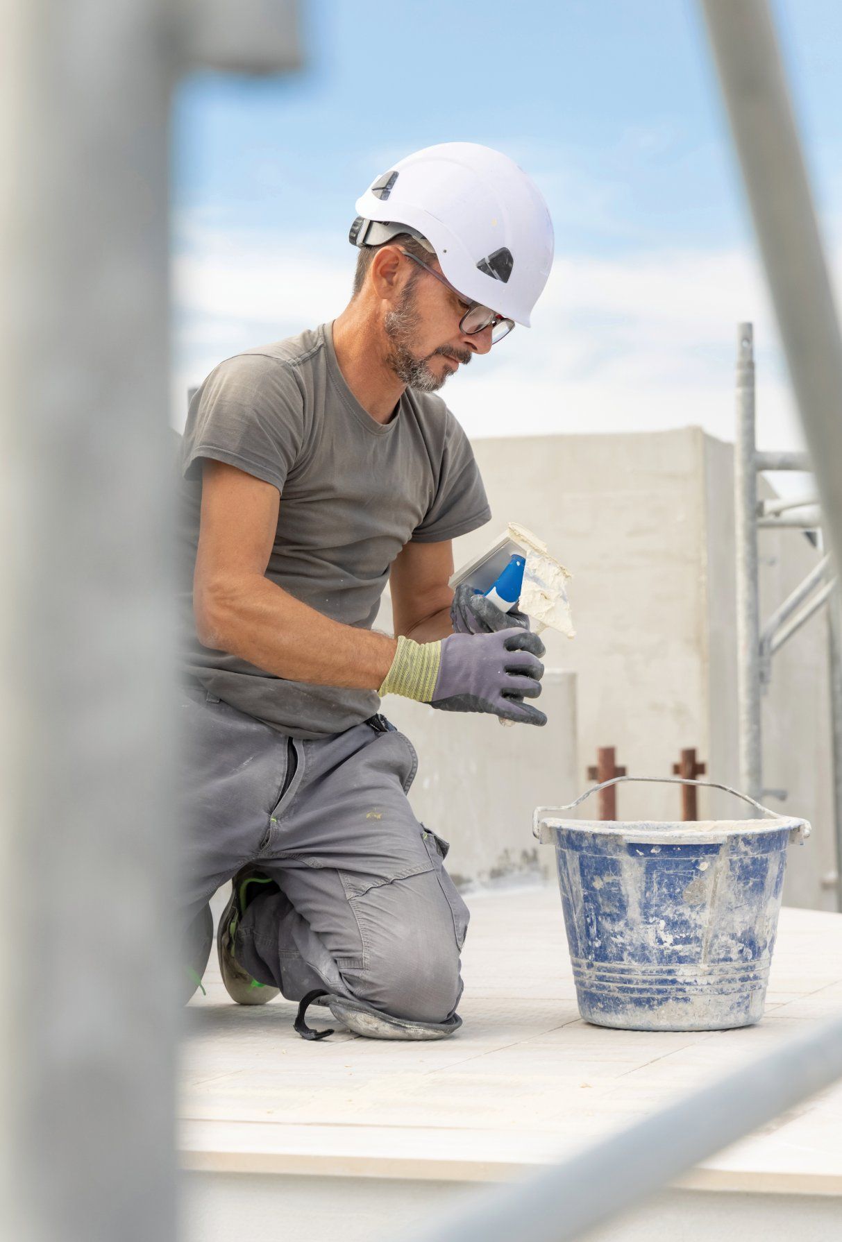 A Man is Cleaning the Side of a Building That Says Sunshine Coast — Commercial Asset Maintenance In North Lakes, QLD