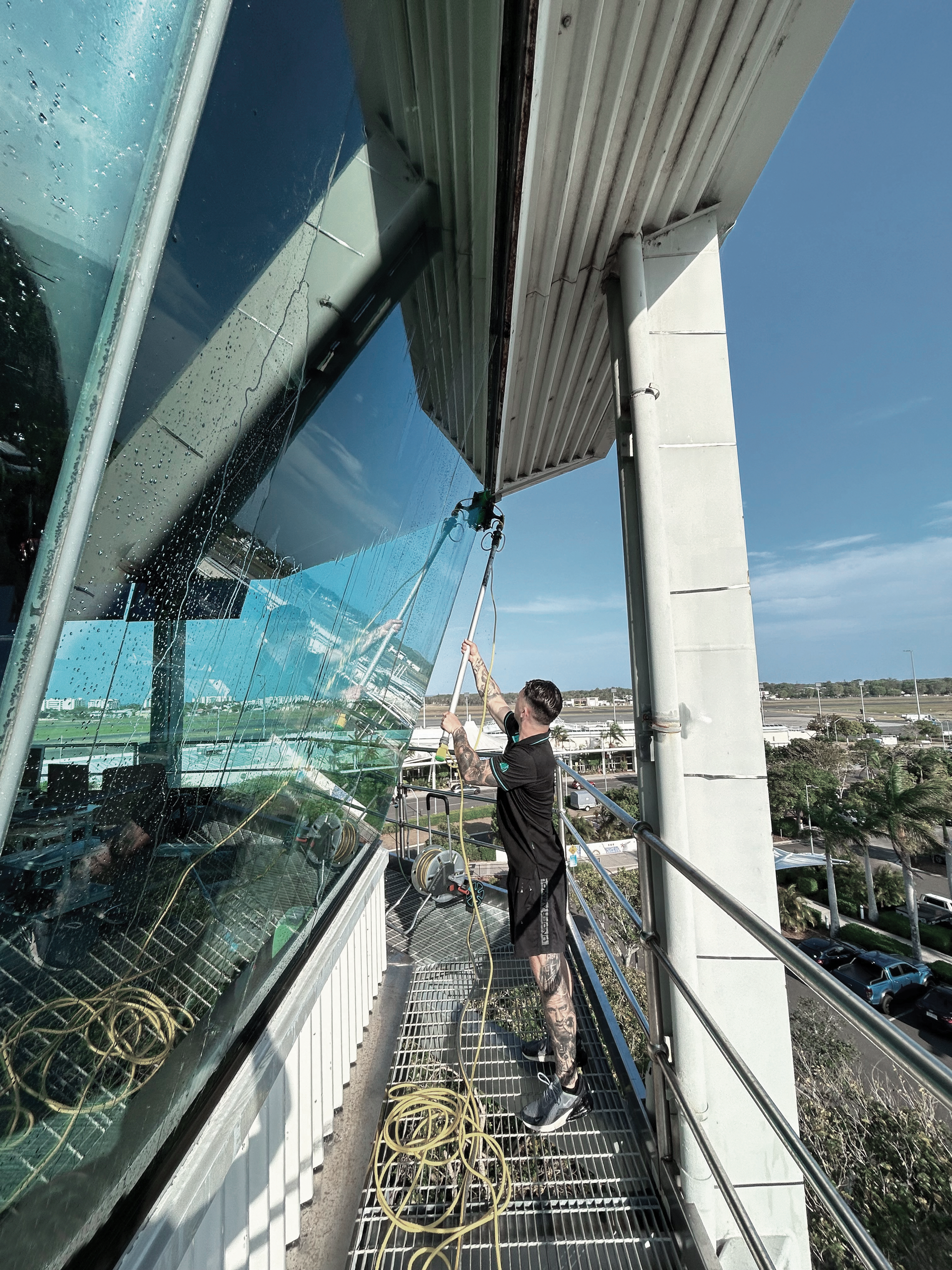 A Man Cleaning Windows — Commercial Asset Maintenance In Maroochydore, QLD